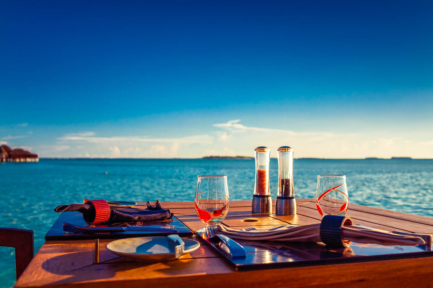 Table setting at tropical beach restaurant during summer - and why food and travel go hand in hand